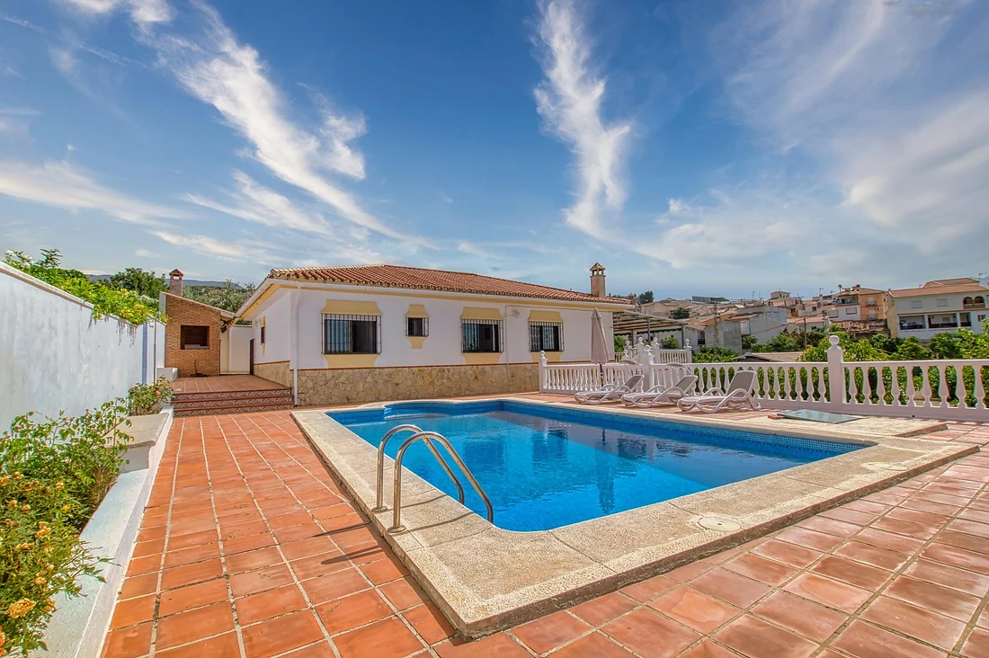 Country home — yet right in the village — with a pool and spectacular views of the mountains, the La Viñuela reservoir and the sea